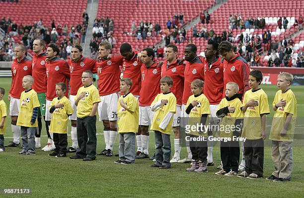 The Toronto FC team stands for the national anthem before a game against Real Salt Lake at Rio Tinto Stadium on May 1, 2010 in Sandy, Utah. Real Salt...