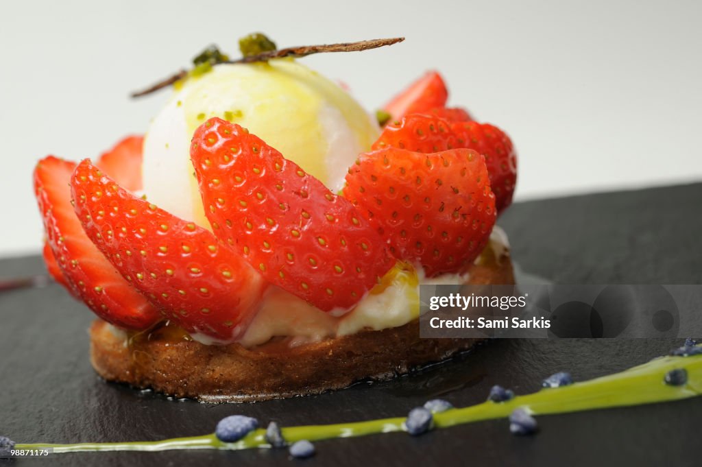 Vanilla Ice Cream with strawberries fruits around
