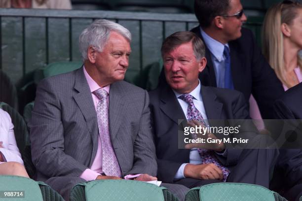 Football manager's Bobby Robson talks with Sir Alex Fergusson during Lleyton Hewitt's match with Younes El Aynaoui in The All England Lawn Tennis...