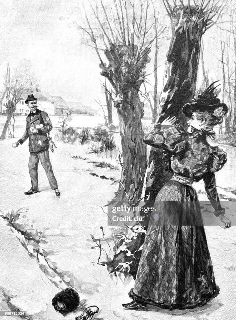 Man and woman have a snowball fight