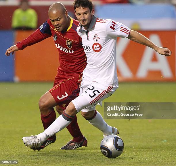 Robbie Russell of Real Salt Lake fights for the ball with Martin Saric of Toronto FC during the game at Rio Tinto Stadium on May 1, 2010 in Sandy,...
