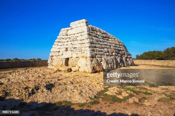 naveta or megalithic tomb at the site of es tudons, menorca, balearic islands, spain, mediterranean, europe - naveta of tudons stock pictures, royalty-free photos & images