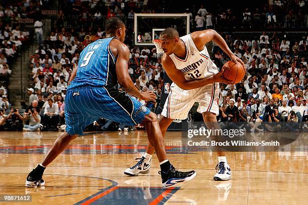 Boris Diaw of the Charlotte Bobcats is guarded by Rashard Lewis of the Orlando Magic in Game Four of the Eastern Conference Quarterfinals during the...