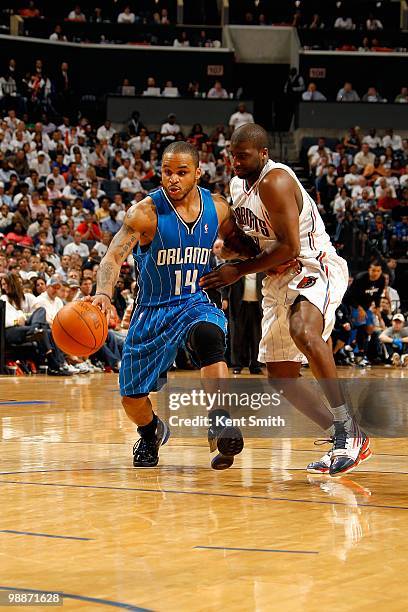 Jameer Nelson of the Orlando Magic drives to the basket against Raymond Felton of the Charlotte Bobcats in Game Four of the Eastern Conference...