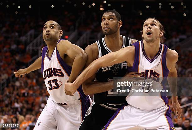 Grant Hill and Louis Amundson of the Phoenix Suns guard against Tim Duncan of the San Antonio Spurs during Game One of the Western Conference...