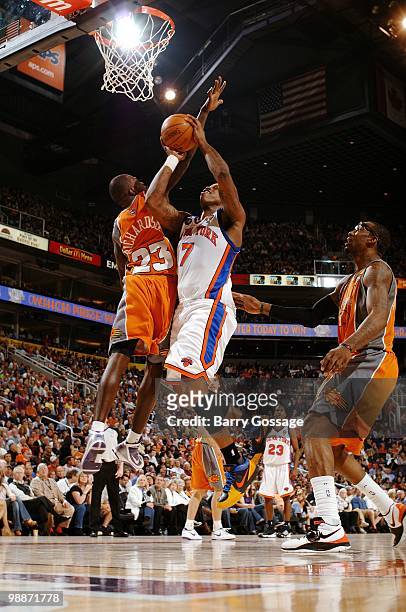 Al Harrington of the New York Knicks puts a shot up against Jason Richardson of the Phoenix Suns during the game at U.S. Airways Center on March 26,...