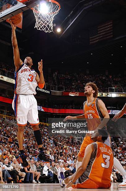 Tracy McGrady of the New York Knicks puts a shot up against Robin Lopez of the Phoenix Suns during the game at U.S. Airways Center on March 26, 2010...