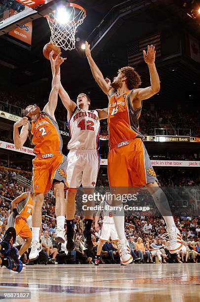 David Lee of the New York Knicks puts a shot up against Goran Dragic and Robin Lopez of the Phoenix Suns during the game at U.S. Airways Center on...