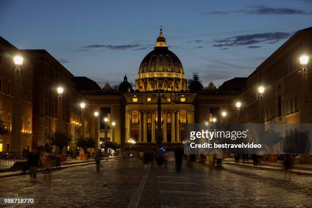 st. peter's cathedral night view with passing crowd, from via della conciliazione, rome, lazio, italy, europe - via della conciliazione stock pictures, royalty-free photos & images