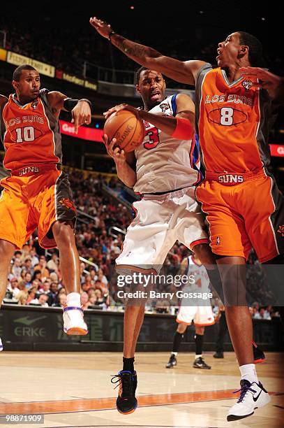 Tracy McGrady of the New York Knicks puts a shot up against Channing Frye of the Phoenix Suns during the game at U.S. Airways Center on March 26,...