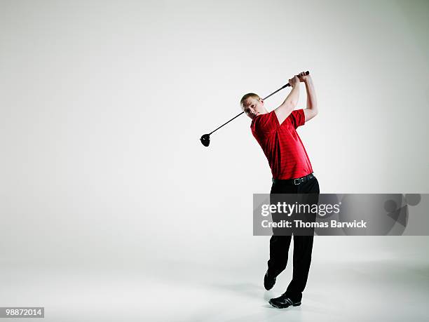 male golfer teeing off with driver golf club - golfer stock pictures, royalty-free photos & images