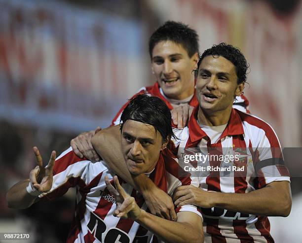 Leandro Gonzalez of Estudiantes celebrates a scored goal with team mates Federico Fernandez and Marcelo Carrusca during a Libertadores Cup match...