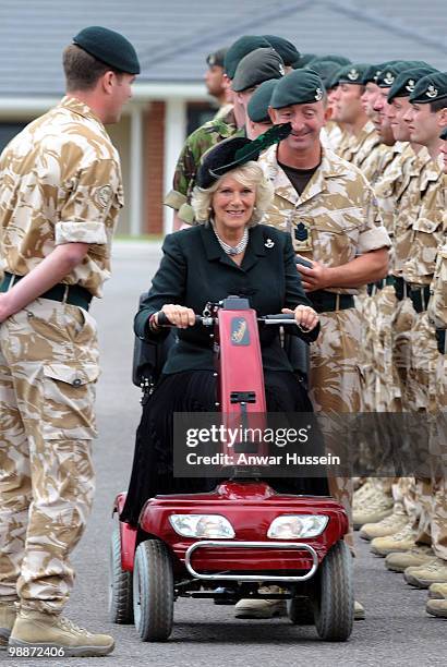 Camilla, Duchess of Cornwall uses a mobility scooter after breaking her leg while walking in Scotland as she presents Afghanistan campaign medals to...