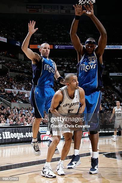 Tony Parker of the San Antonio Spurs goes to the basket against Jason Kidd and Erick Dampier of the Dallas Mavericks in Game Three of the Western...