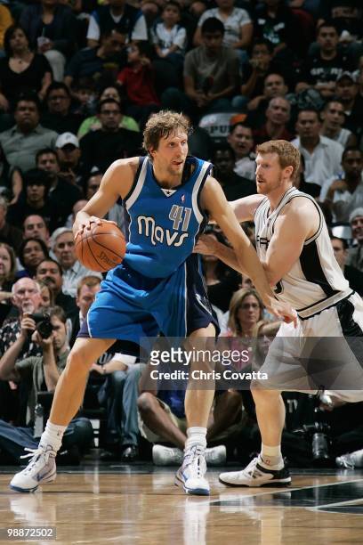 Dirk Nowitzki of the Dallas Mavericks handles the ball against Matt Bonner of the San Antonio Spurs in Game Three of the Western Conference...