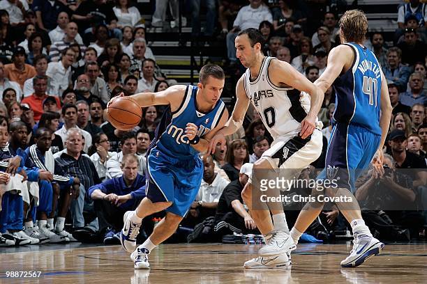 Jose Barea of the Dallas Mavericks drives against Manu Ginobili of the San Antonio Spurs in Game Three of the Western Conference Quarterfinals during...