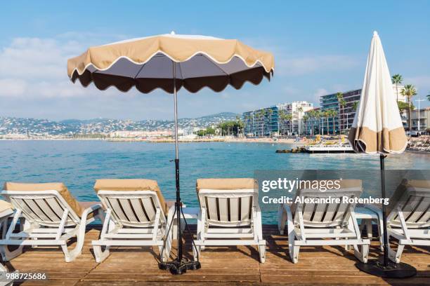 rows of empty beach lounges in juan les pins, cote d'azur, provence, france, mediterranean, europe - juan les pins bildbanksfoton och bilder