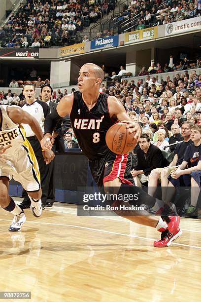 Carlos Arroyo of the Miami Heat dribbles the ball downcourt against the Indiana Pacers during the game at Conseco Fieldhouse on April 2, 2010 in...