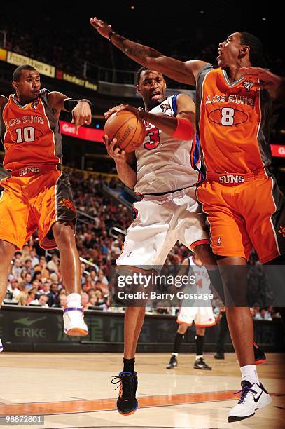 Tracy McGrady of the New York Knicks puts a shot up against Channing Frye of the Phoenix Suns during the game at U.S. Airways Center on March 26,...