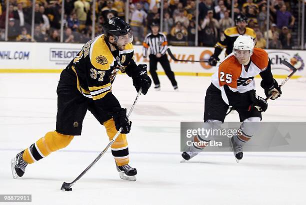 Patrice Bergeron of the Boston Bruins takes a shot as Matt Carle of the Philadelphia Flyers defends in Game Two of the Eastern Conference Semifinals...