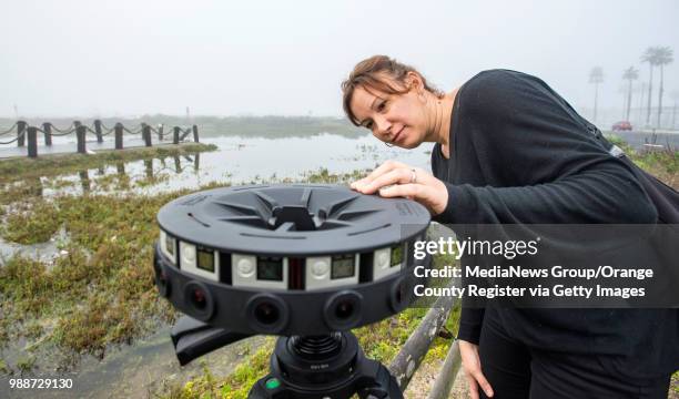 Juliette Finzi Hart with the U.S. Geological Survey, sets up a 360 degree video camera made by Google to record a high tide in the Bolsa Chica...