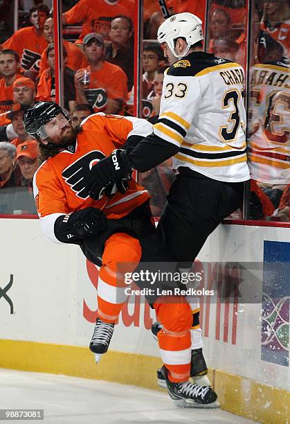 Scott Hartnell of the Philadelphia Flyers collides with Zdeno Chara of the Boston Bruins along the boards in Game Three of the Eastern Conference...