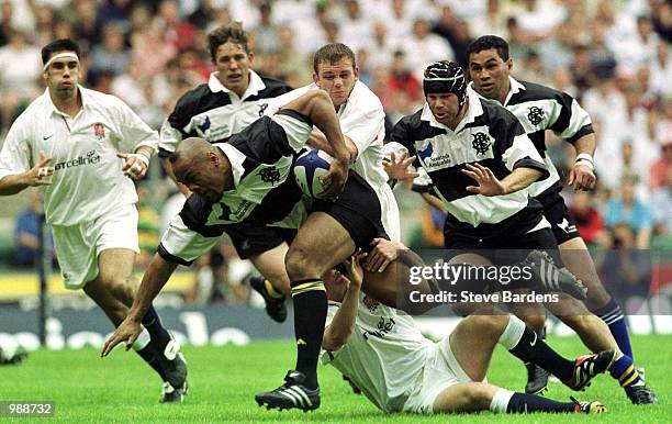 Jonah Lomu of the Barbarians breaks a tackle during the match between England and the Barbarians played at Twickenham, London. Mandatory Credit:...