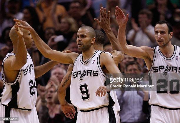 Tony Parker of the San Antonio Spurs reacts with Richard Jefferson and Manu Ginobili against the Dallas Mavericks in Game Three of the Western...