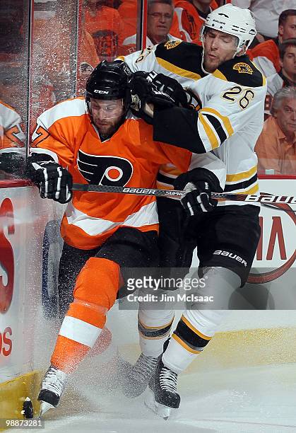 Ryan Parent of the Philadelphia Flyers is checked off the puck by Blake Wheeler of the Boston Bruins in Game Three of the Eastern Conference...