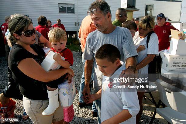 Unemployed commercial fishermen and their families wait in line to receive hand-outs from New Orleans Catholic Charities on May 5, 2010 in Hopedale,...