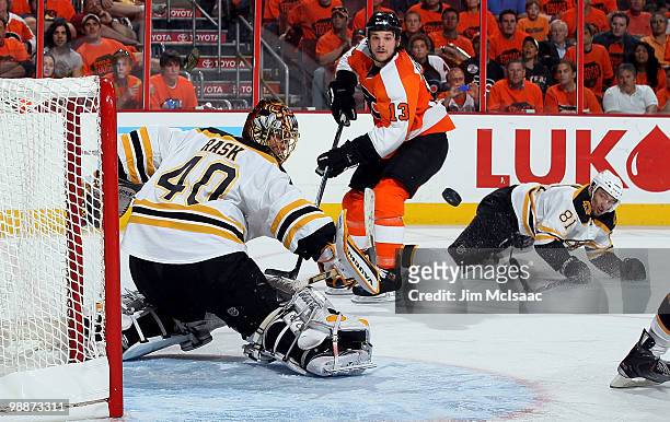Tuukka Rask of the Boston Bruins makes a save against Daniel Carcillo of the Philadelphia Flyers in Game Three of the Eastern Conference Semifinals...