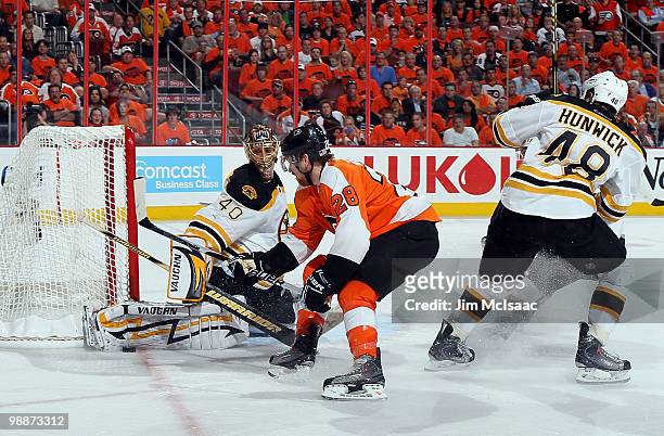 Tuukka Rask of the Boston Bruins makes a save against Claude Giroux of the Philadelphia Flyers in Game Three of the Eastern Conference Semifinals...
