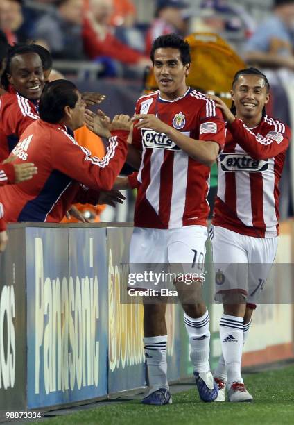 Jesus Padilla of Chivas USA celebrates his goal with teammates on the bench in the first half against the New England Revolution on May 5, 2010 at...