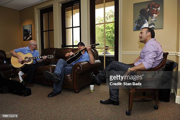 Recording artist Tim McGraw, with fellow band members warm up before performing at the Military Appreciation Ceremony prior to the start of THE...