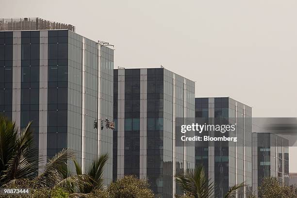 Window cleaner works on the Maker Maxity towers in the Bandra Kurla Complex of Mumbai, India, on Friday, April 30, 2010. UBS AG and JPMorgan Chase &...