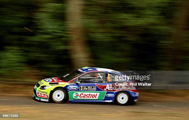 Mikko Hirvonen and co-driver Jarmo Lehtinen of Finland drive their Ford Focus RS through the streets of the Auckland Domain during the WRC Rally of...