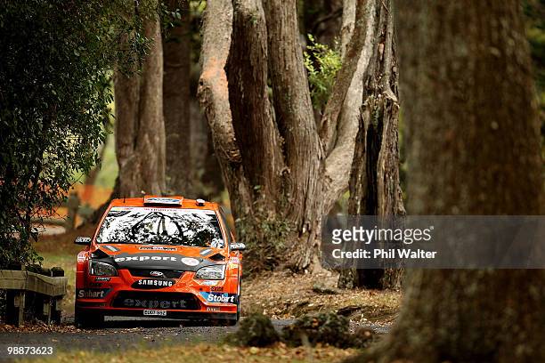 Henning Solberg of Norway and co-driver Ilka Minor of Austria drive their Ford Focus RS WRC through the streets of the Auckland Domain during the WRC...