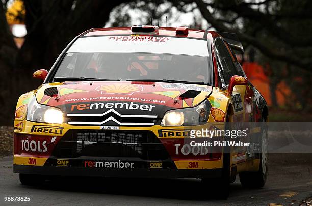 Petter Solberg of Norway and co-driver Phil Mills of Great Britain drive their Citroen C4 WRC through the streets of the Auckland Domain during the...