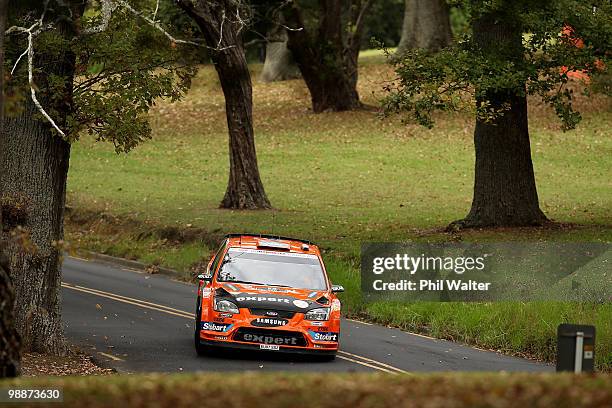 Henning Solberg of Norway and co-driver Ilka Minor of Austria drive their Ford Focus RS WRC through the streets of the Auckland Domain during the WRC...