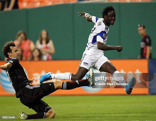 Kei Kamara of the Kansas City Wizards shoots the ball against Carey Talley of D.C. United at RFK Stadium on May 5, 2010 in Washington, DC.