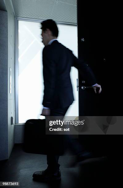 businessman going out of the room - newbusiness stock pictures, royalty-free photos & images