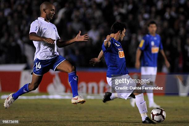 Mario Regueiro of Nacional fights for the ball with Kleber of Cruzeiro during a match as part of the Libertadores Cup 2010 at Central Park Stadium on...