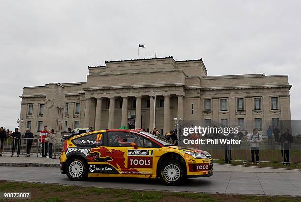 Petter Solberg of Norway and co-driver Phil Mills of Great Britain drive their Citroen C4 WRC through the streets of the Auckland Domain during the...