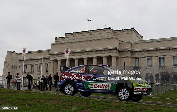 Mikko Hirvonen and co-driver Jarmo Lehtinen of Finland drive their Ford Focus RS through the streets of the Auckland Domain during the WRC Rally of...