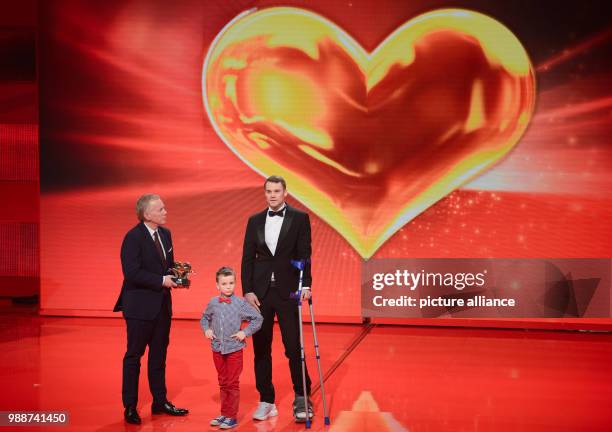 Frederik awarding soccer player Manuel Neuer from FC Bayern Munich with the Golden Heart during the charity gala "A heart for children" in Berlin,...