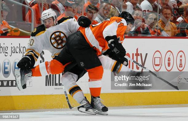 Kimmo Timonen of the Philadelphia Flyers collidesa with Daniel Paille of the Boston Bruins in Game Three of the Eastern Conference Semifinals during...
