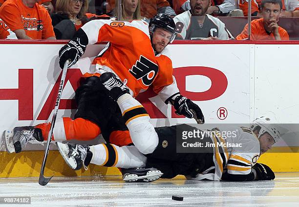Darroll Powe of the Philadelphia Flyers gets tangled up with Dennis Wideman of the Boston Bruins in Game Three of the Eastern Conference Semifinals...