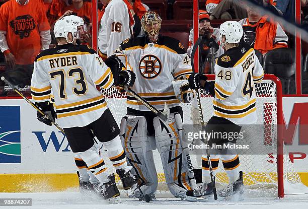 Tuukka Rask of the Boston Bruins celebrates with his teammates after defeating the Philadelphia Flyers in Game Three of the Eastern Conference...