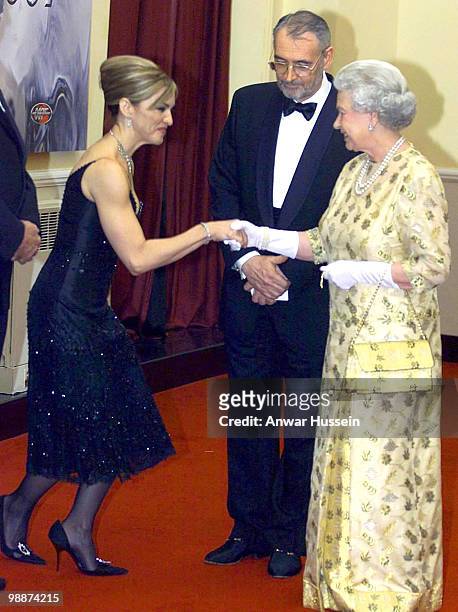 Queen Elizabeth II with Madonna and producer Michael G. Wilson