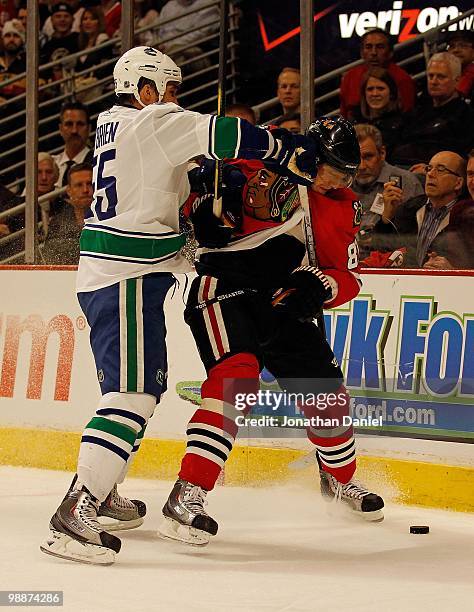 Marian Hoosa of the Chicago Blackhawks is hit by Shane O'Brien of the Vancouver Canucks in Game Two of the Western Conference Semifinals during the...